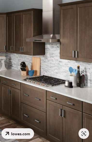 a kitchen with brown cabinets and white counter tops