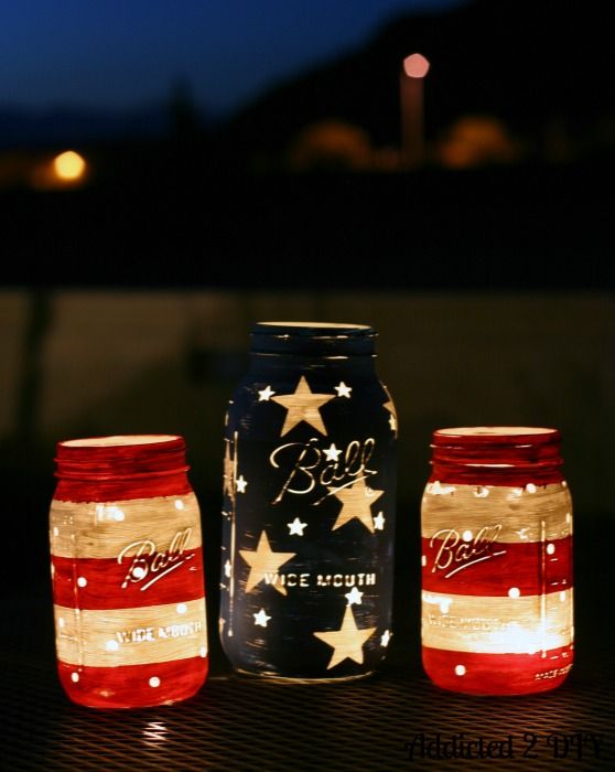 three mason jars with lights in them sitting next to each other on top of a table