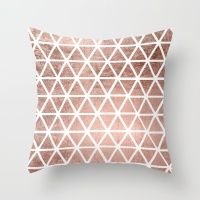 a pink and white pillow with geometric shapes on it