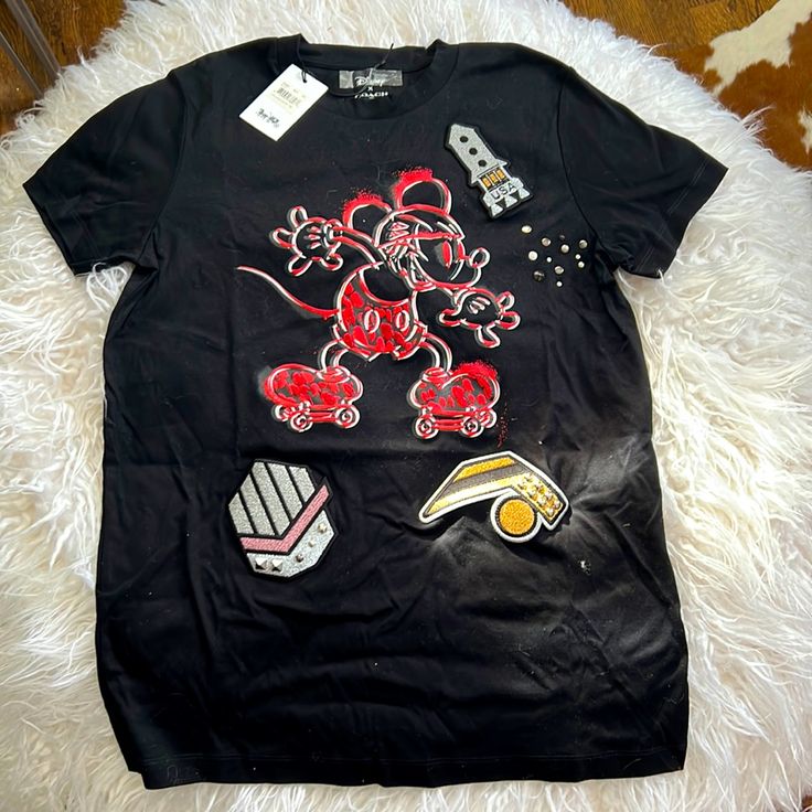 Exclusive, Disney X Coach Mickey T-Shirt Brand New With Tags I Also Have The Bag With Coach Mickey Stickers Size Is Extra Small, But Can Definitely Fit A Small Sporty Mickey Mouse Crew Neck Top, Disney Cotton Tops With Embroidered Graphics, Black Disney Fan Merchandise T-shirt, Casual Embroidered Graphics T-shirt For Fans, Casual T-shirt With Embroidered Graphics For Fans, Mickey Mouse Crew Neck Top For Streetwear, Disney Mickey Mouse T-shirt For Streetwear, Black Mickey Mouse Tops For Disney Events, Black Disney Tops With Cartoon Print For Fan Events