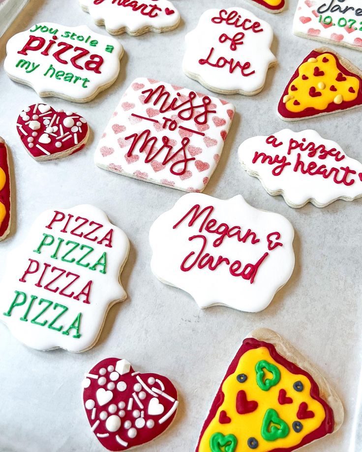 many decorated cookies are on a baking sheet and ready to be cut into the shape of hearts