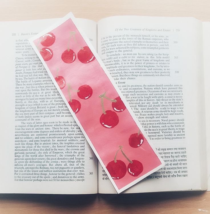 an open book with cherries on it