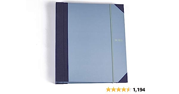 a blue notebook sitting on top of a white table