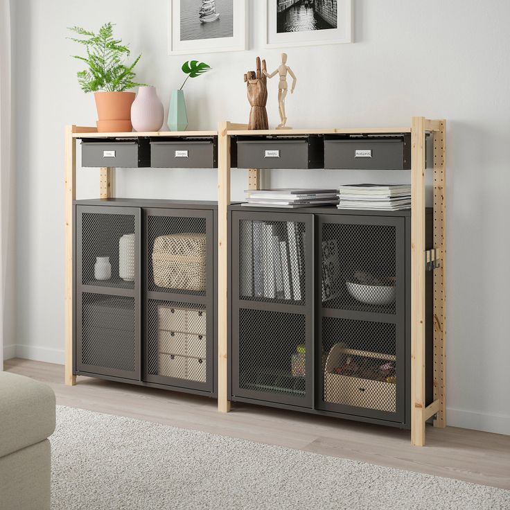 a living room with two shelves and some pictures on the wall