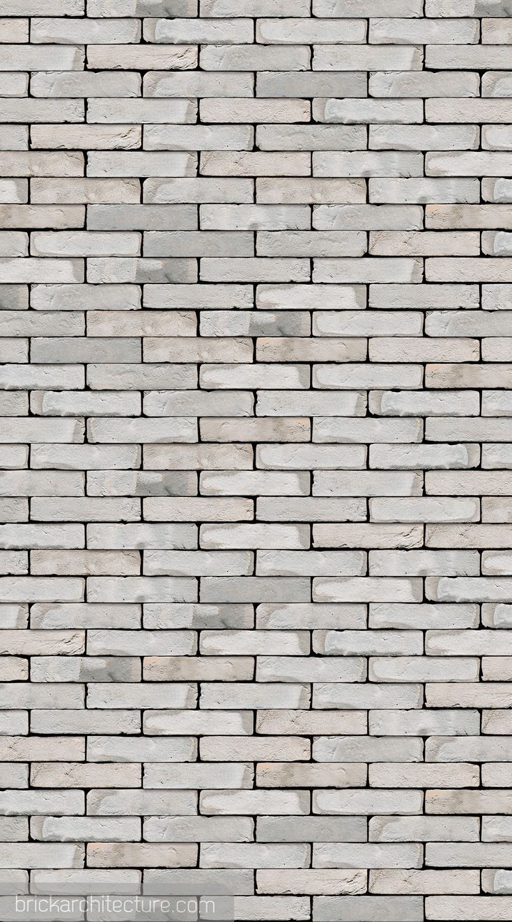 a white brick wall textured with gray bricks