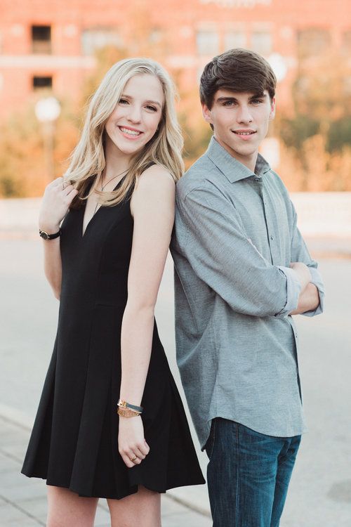 a young man and woman standing next to each other