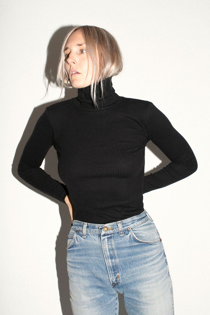 Perfect basic turtleneck in a thick ribbed knit. Fabric is 100% organic cotton. Ella is 6' tall, 36" bust, 26" waist, 36" hip, and is wearing a size S. Classic Ribbed Winter Tops, Black Ribbed Tops For Fall, Black Ribbed Turtleneck For Winter, Fitted Cotton Turtleneck, Classic Ribbed Turtleneck Top, Ribbed Cotton Turtleneck Top, Ribbed Turtleneck Winter Sweater, Winter Ribbed Tops For Layering, Winter Turtleneck Sweater With Ribbing