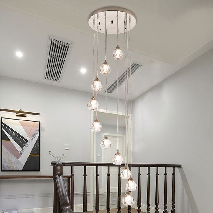 a staircase with lights hanging from the ceiling