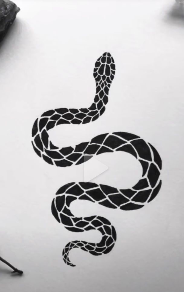 a drawing of a snake on top of a white paper next to a black pen