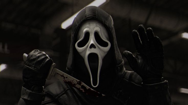 a person in a black outfit with a white mask holding a knife and looking at the camera