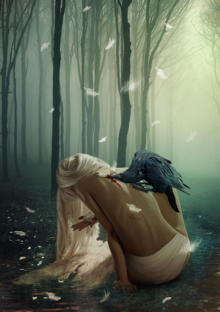 a woman laying in the woods with a bird on her head and birds flying around