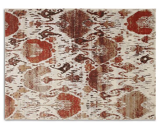 an area rug with red and white designs on the front, in various shades of brown