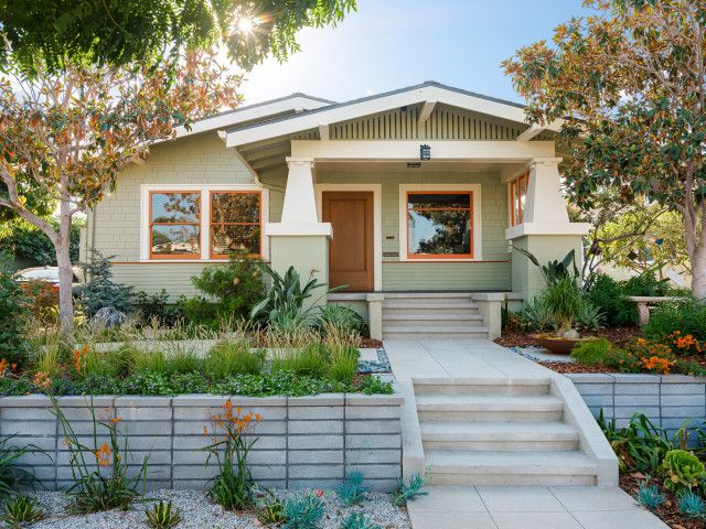 a house with landscaping and steps leading to the front door