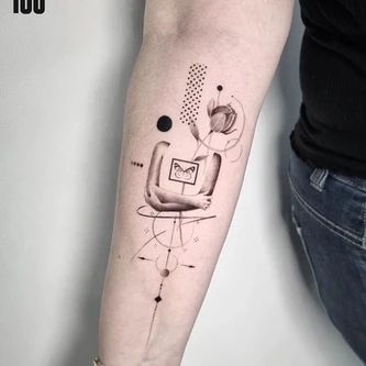 a woman's arm with a tattoo on it and an image of a computer