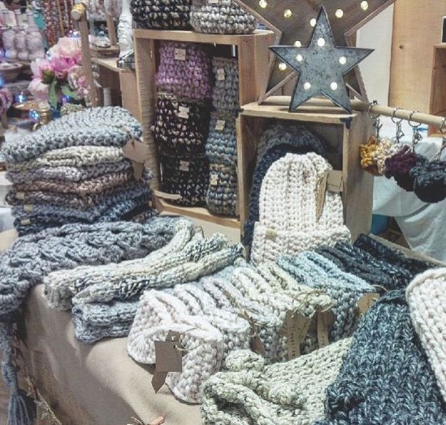 many knitted items are on display at the market