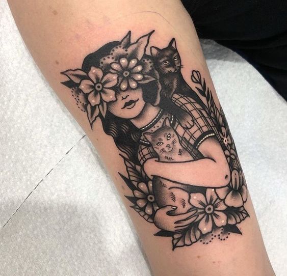 a woman with a cat tattoo on her arm