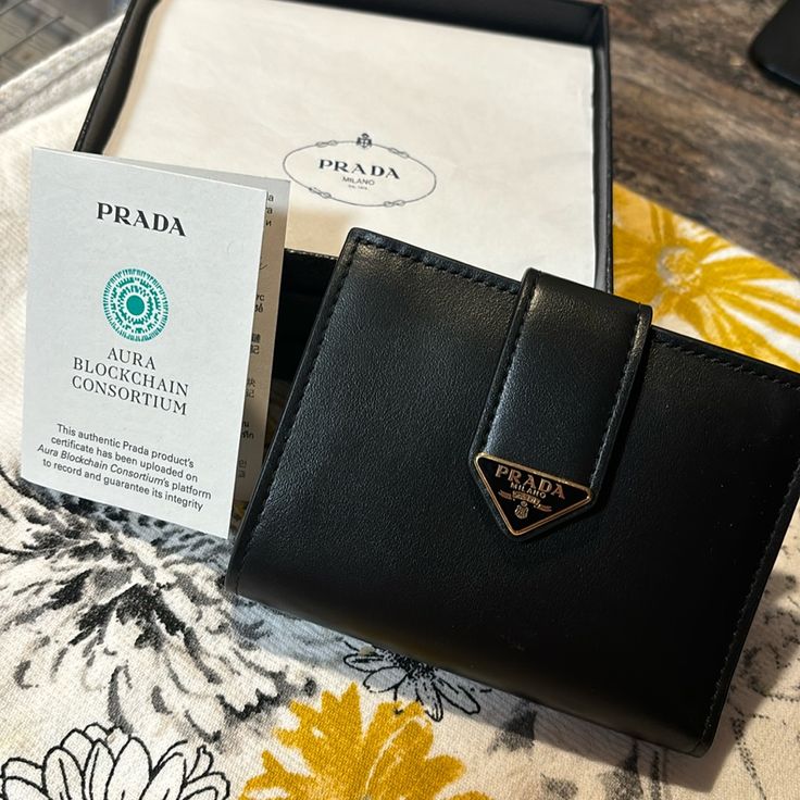 Brand New Small Saffiano Smooth Black Leather Wallet. Bought In Italy In Early October. Brand New!!! Comes With Certificate Of Authenticity, Card Inserts, And Original Box With Tissue Paper. Smoke Free Home. Smooth Black Leather Gold Signature Triangle Emblem And Buttons. Free Shipping Retails 750 On Prada Website. *Will Go Directly To Poshmark Hq To Be Authenticated Before It Comes To You!!* Everyday Wallets With Logo Plaque, Designer Evening Wallets With Logo Plaque, Luxury Wallet With Logo Plaque For Everyday Use, Designer Black Saffiano Leather Wallets, Luxury Wallet With Logo Plaque, Designer Evening Wallets With Rfid Blocking, Designer Rfid Blocking Wallets For Evening, Luxury Saffiano Leather Wallet For Evening, Elegant Evening Wallet In Saffiano Leather