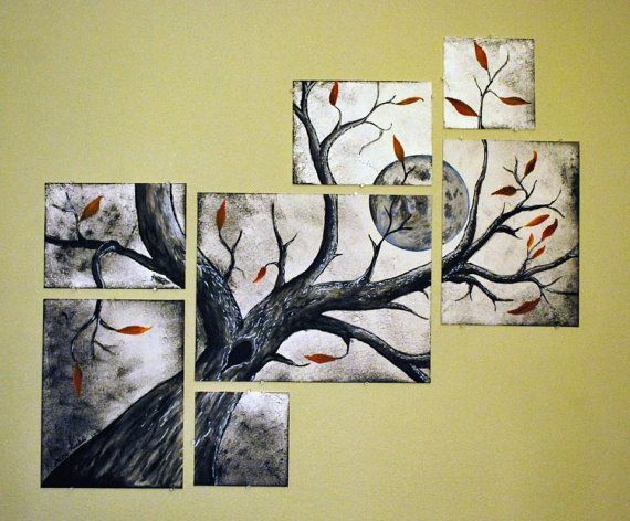 four paintings are hanging on the wall in front of a tree with red leaves and a full moon