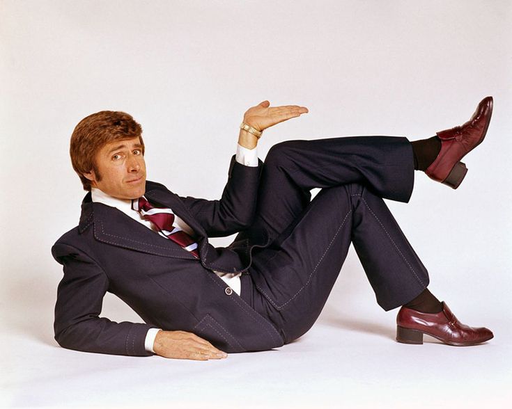 a man in a suit and tie laying on the ground