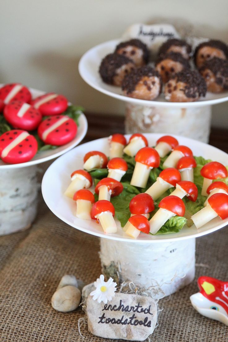 three tiered plates filled with food on top of a table next to each other