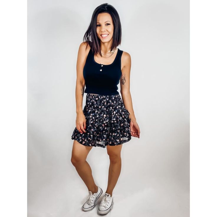 You and this Black Floral Ruffled Mini Skirt make a perfect pair! Lightweight woven fabric shapes a high-waisted, A-line silhouette, a smocked stretchy waistband and a tiered skirt with a flirty mini hem and ruffle accents. 100% Rayon Size+Fit: (All measurements are approximate and taken unstretched)-Fits true to size-Smocked waist has a lot of room for stretch-Size S: Length 16"-Size M: Length 17"-Size L: Length 18" Black Ruffled Mini Skirt For Summer, Black Ruffled Mini Skirt, Flirty Black Mini Skirt With Ruffles, Black Floral Print Tiered Skirt, Black Floral Print Mini Skirt, Ruffled Mini Skirt, Black Floral, Woven Fabric, Skater Skirt