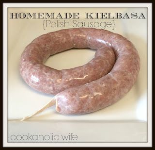 a large sausage sitting on top of a white counter next to a sign that says homemade kielbasa polish sausage