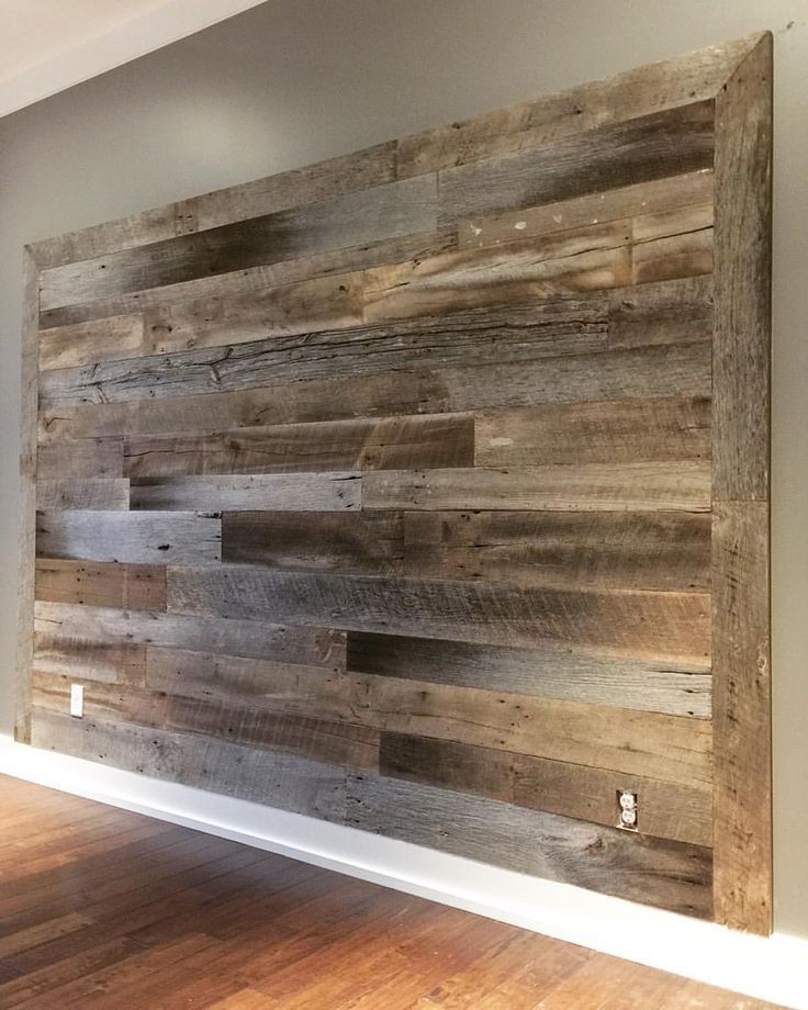 a wall made out of wooden planks in an empty room