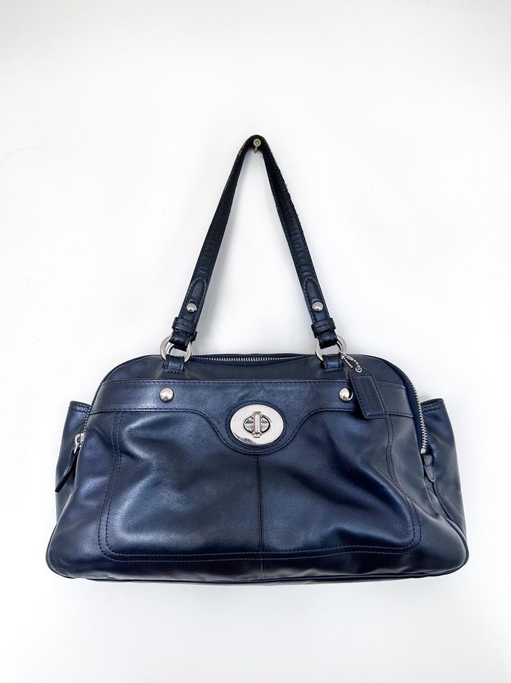 COACH wide shoulder bag in a stunning iridescent navy blue. Featuring a front lock closure compartment, two large zipper compartments, and a large magnetic button closure compartment in the middle. Add the perfect pop of colour to any outfit. Please note there is minor wear on the top of the shoulder straps (pictured). Brand: COACH Composition: Genuine Leather  Size: L 16" x W 5" x H 9" (without straps) H 6" (including straps). Blue Shoulder Bag, Navy Bag, Upcycle Recycle, Blue Purse, Metallic Blue, Packing Material, Vintage Vibes, Blue Bags, Coach Handbags