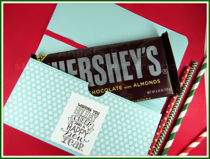 hershey's chocolate with almonds and candy bar wrapper on red background