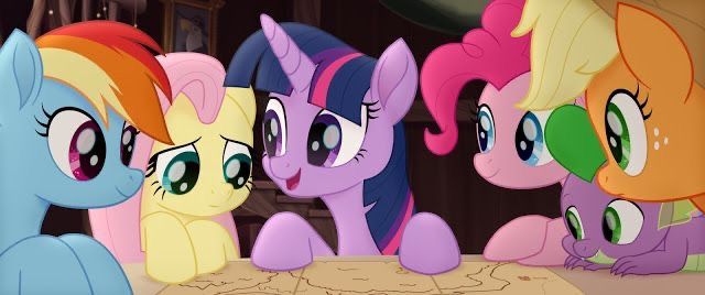 many different colored ponies are lined up in front of each other on a table