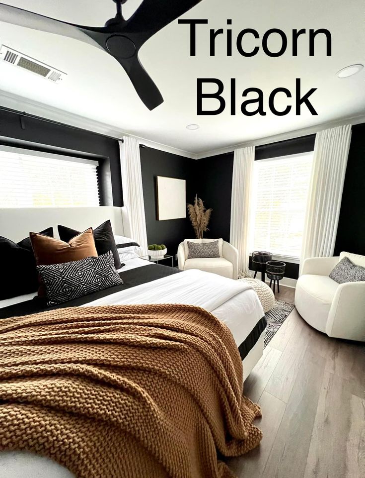 a bedroom with black walls and white furniture