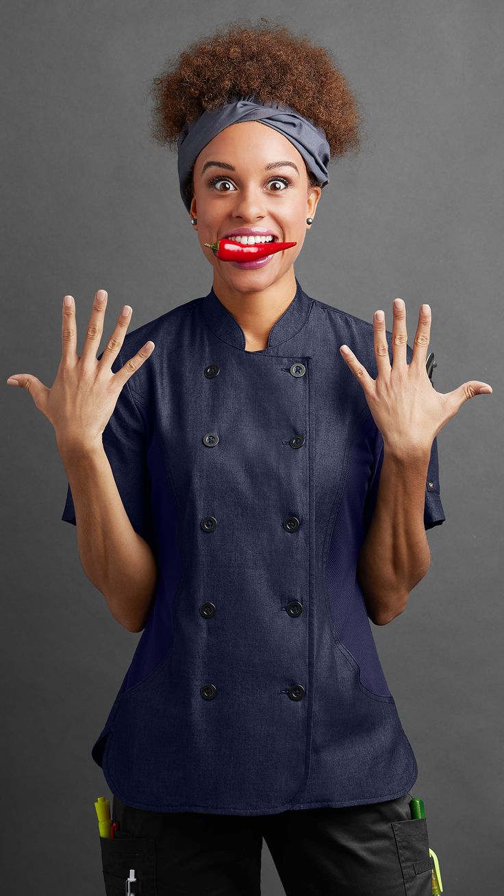 a woman with her hands in the air while wearing a blue jacket and red lipstick