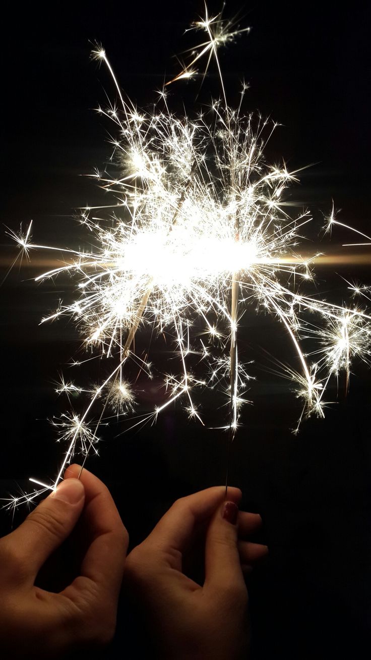 someone is holding a sparkler in their hand and it looks like they are going to fly