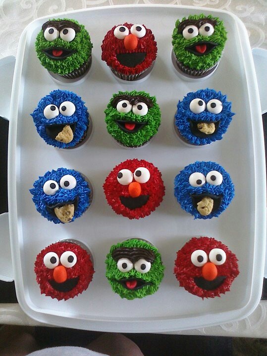 the cupcakes are decorated like sesame street characters