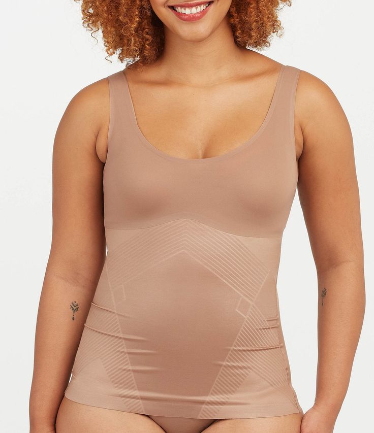 From Spanx&#x2C; this tank features:Lightweight&#x2C; single-layer tummy shaping Flat neckline & armhole stay invisible under clothes Fit-flexible hem construction Body: Nylon/Lycra® elastane; bust: nylon/elastaneMachine wash cold/gentle cycle/do not use fabric softener/only non-chlorine bleach when needed/tumble dry low/do not ironImported. Solid Compression Sleeveless Shapewear, Fitted Sports Shapewear With Built-in Bra, Shapewear Tank Top With Built-in Bra And Wide Straps, Sleeveless Stretch Shapewear With Built-in Bra, Compression Shapewear With Built-in Bra In Elastane, Compression Shapewear With Built-in Bra, Compression Shapewear With Built-in Bra Sleeveless, Compression Scoop Neck Top With Built-in Bra, Compression Sleeveless Shapewear With Built-in Bra