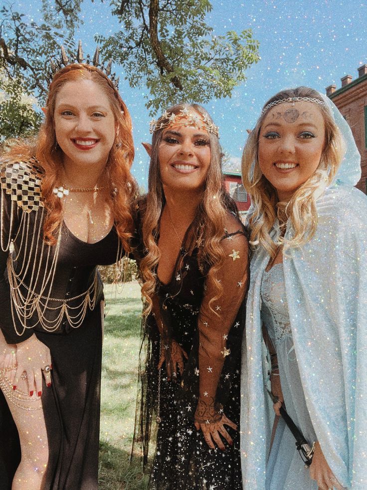 three women dressed in costumes pose for the camera with confetti falling all over them