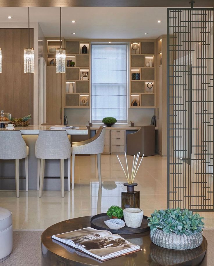 a living room filled with furniture next to a dining room table and kitchen counter top