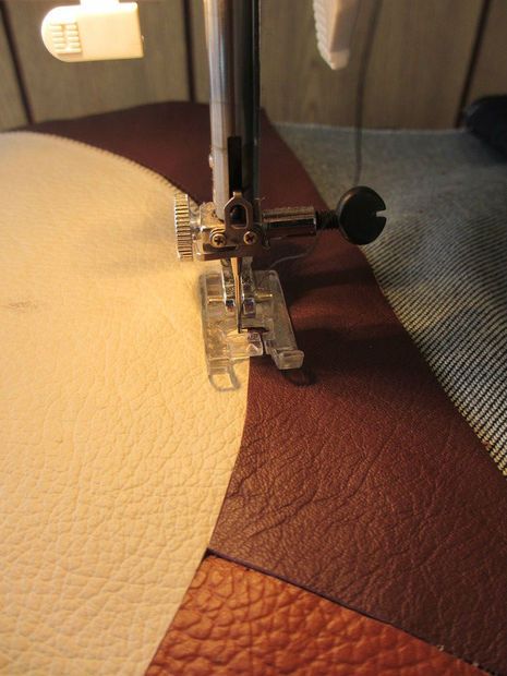 the sewing machine is on top of the quilting material that has been stitched together