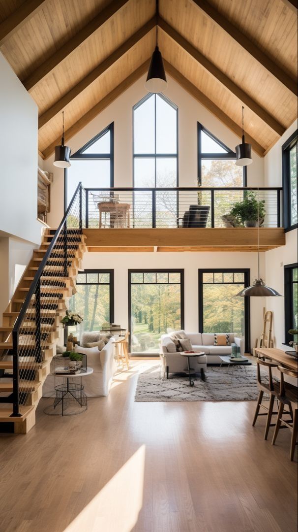 a living room filled with furniture next to a wooden floor covered in windows and stairs