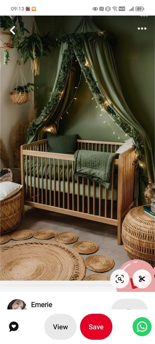 the baby crib is decorated with greenery and lights