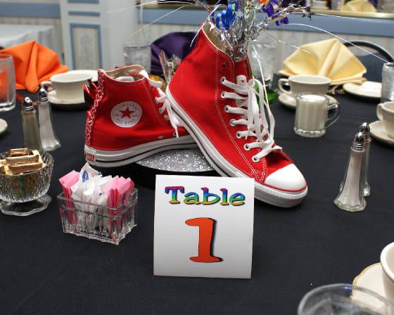 a table topped with red sneakers and place cards