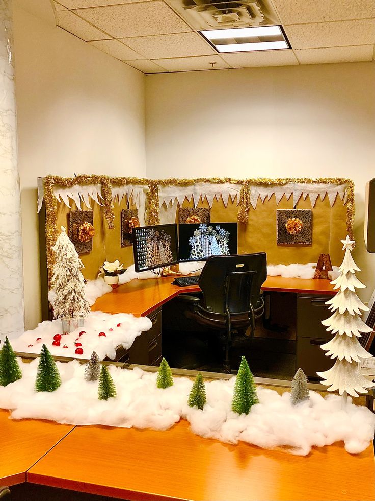 an office cubicle decorated for christmas with fake snow and trees on the desks