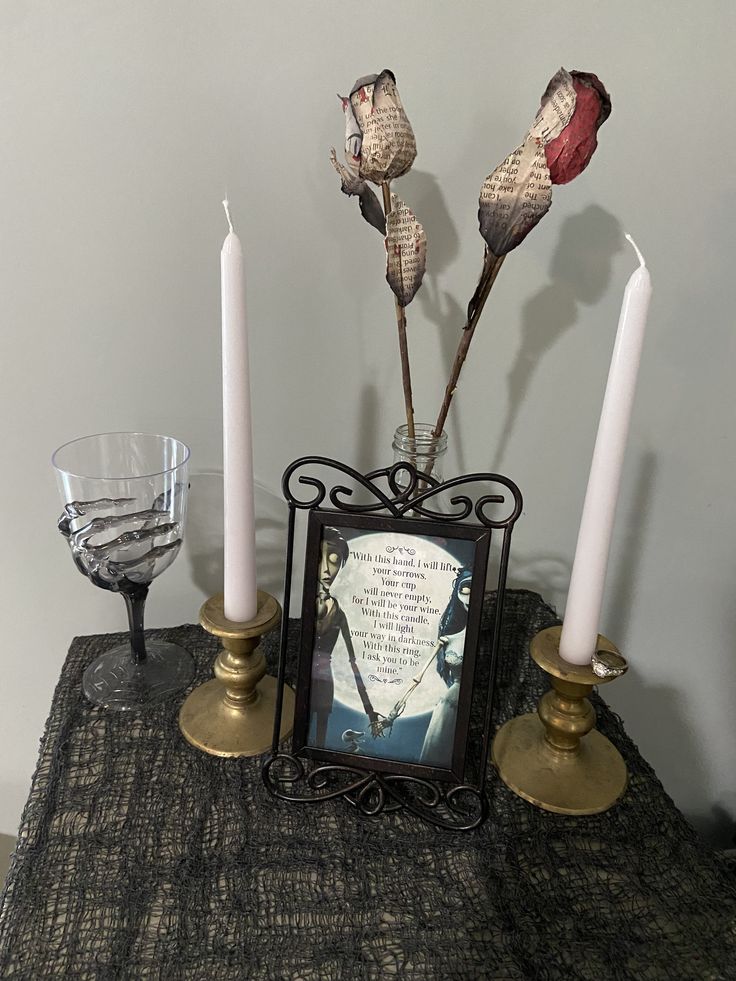 three candles are sitting on a table next to a photo