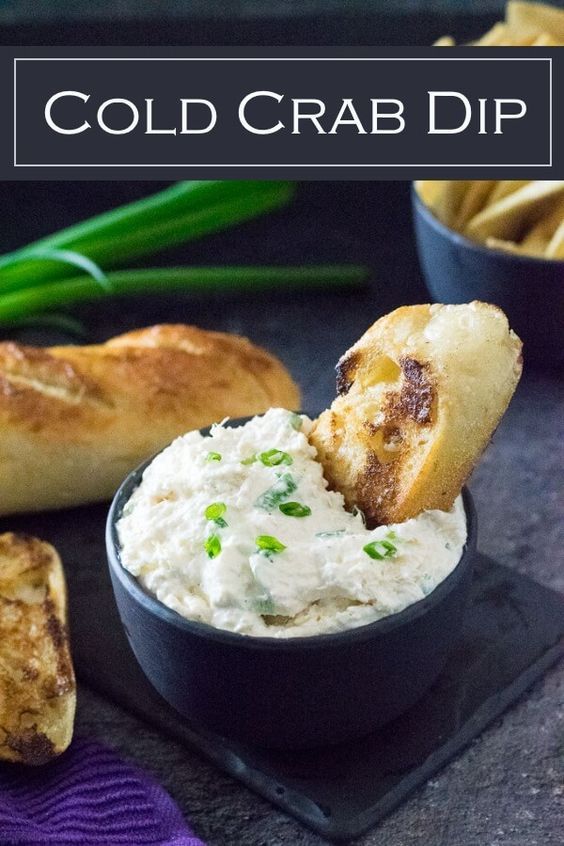 a black plate topped with bread and dip