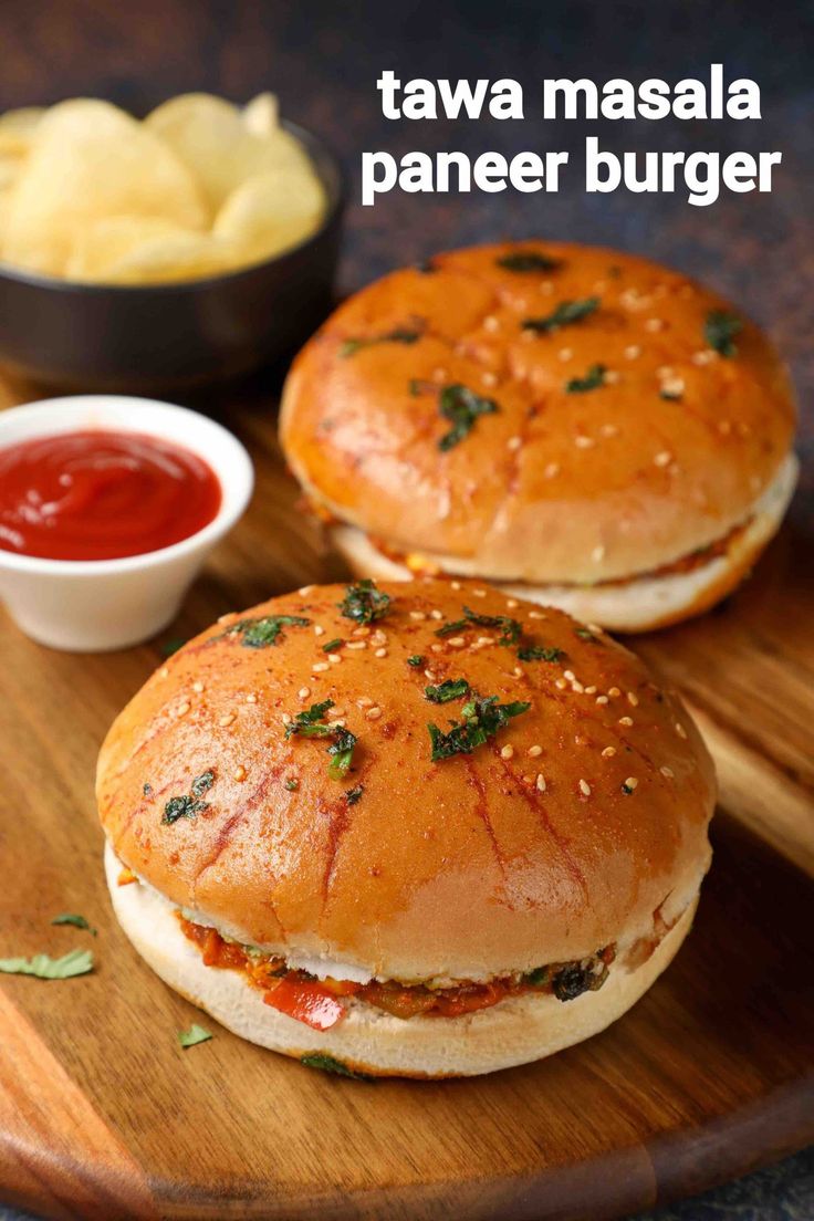 two burgers sitting on top of a wooden cutting board