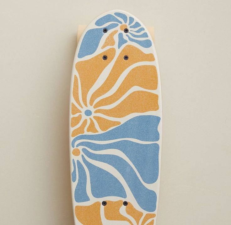 an orange and blue skateboard hanging on the wall