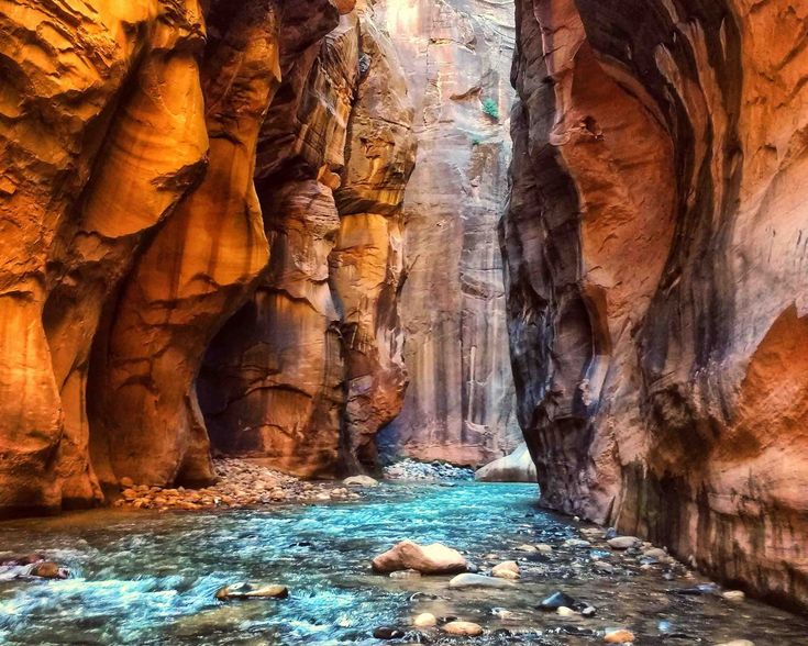 a narrow canyon with water running through it