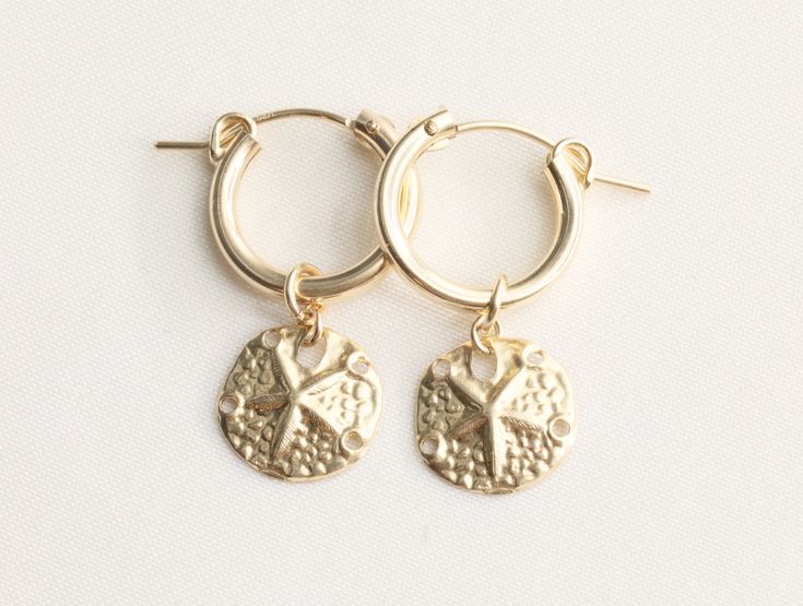 14k Gold Filed Sand Dollar Earrings, Gold Earrings, Starfish Earrings, Beach Earrings, Seashell Earrings, Beachy jewelry, Drop Earrings, Gold Dollar Earrings, Simple Earrings, Earrings Gift for Her Friend, Summer Jewelry, Tropical Earrings, Ocean Lover Gift - 14k gold filled 11mm sand dollar charm AVAILABLE SIZE + 15mm Gold Filled Flex Hoop Earrings - Sold as a pair - Material: 14k Gold Filled - Tarnish free, hypoallergenic, nickel free and safe for sensitive skin 💰 We guaranteed fair pricing o Gold Nickel-free Earrings For Vacation, Nickel-free Gold Earrings For Vacation, Gold Starfish Jewelry For Vacation, Gold Jewelry With Star Charm For Vacation, Gold Star Charm Jewelry For Vacation, Yellow Gold Starfish Charm Jewelry For Beach, Gold Round Earrings For Vacation, Gold 14k Gold Filled Earrings For Beach, Yellow Gold Starfish Earrings For Gift