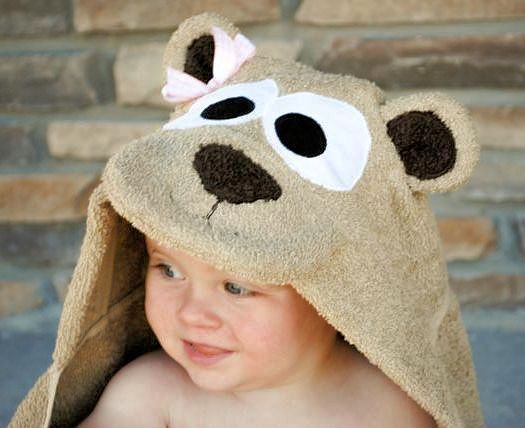 a small child wearing a towel with a teddy bear on it's head and eyes