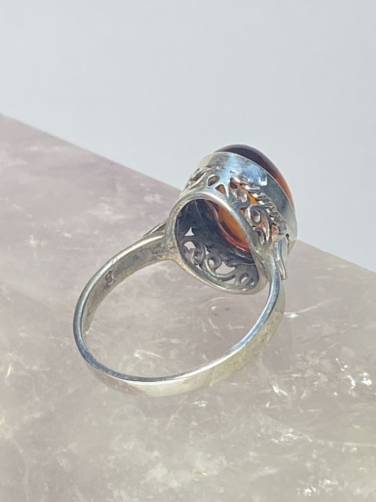 "Amber ring sterling silver lacework filigree women Size. 8.25 Between a size 8.25 and a size 8.50 Weight 3.6g Length. 5/8\" \" Width 3/8\" Narrowest part of band 1/8\" Free Shipping & Free Postal Insurance Delivered in a Gift Box If you do not want the ring polished and want to leave the natural patina please let me know at the time of purchase as I do polish rings before I ship rings out. Thanks Free First Class shipping and postal insurance is included. If you want to upgrade to priority Antique Adjustable Rings With Intricate Design, Nickel-free Silver Engraved Ring, Nickel-free Engraved Silver Ring, Classic Engraved Filigree Ring, Sterling Silver Filigree Ring For Formal Occasions, Ornate Sterling Silver Filigree Ring, Ornate Filigree Ring For Promise, Nickel-free Adjustable Engraved Ring, Ornate Filigree Promise Ring